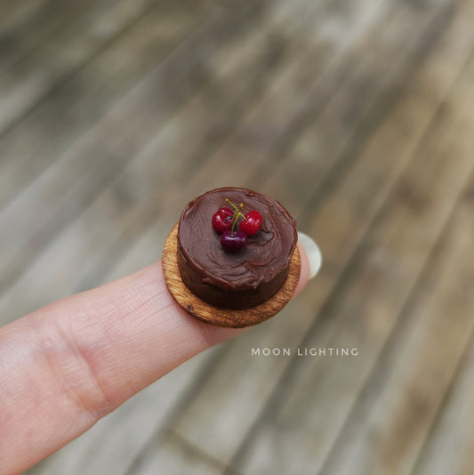 Tiny chocolate cake with cherries