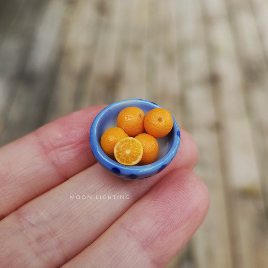 Blue bowl of oranges