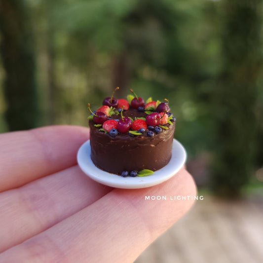 Chocolate cake with berries on white plate