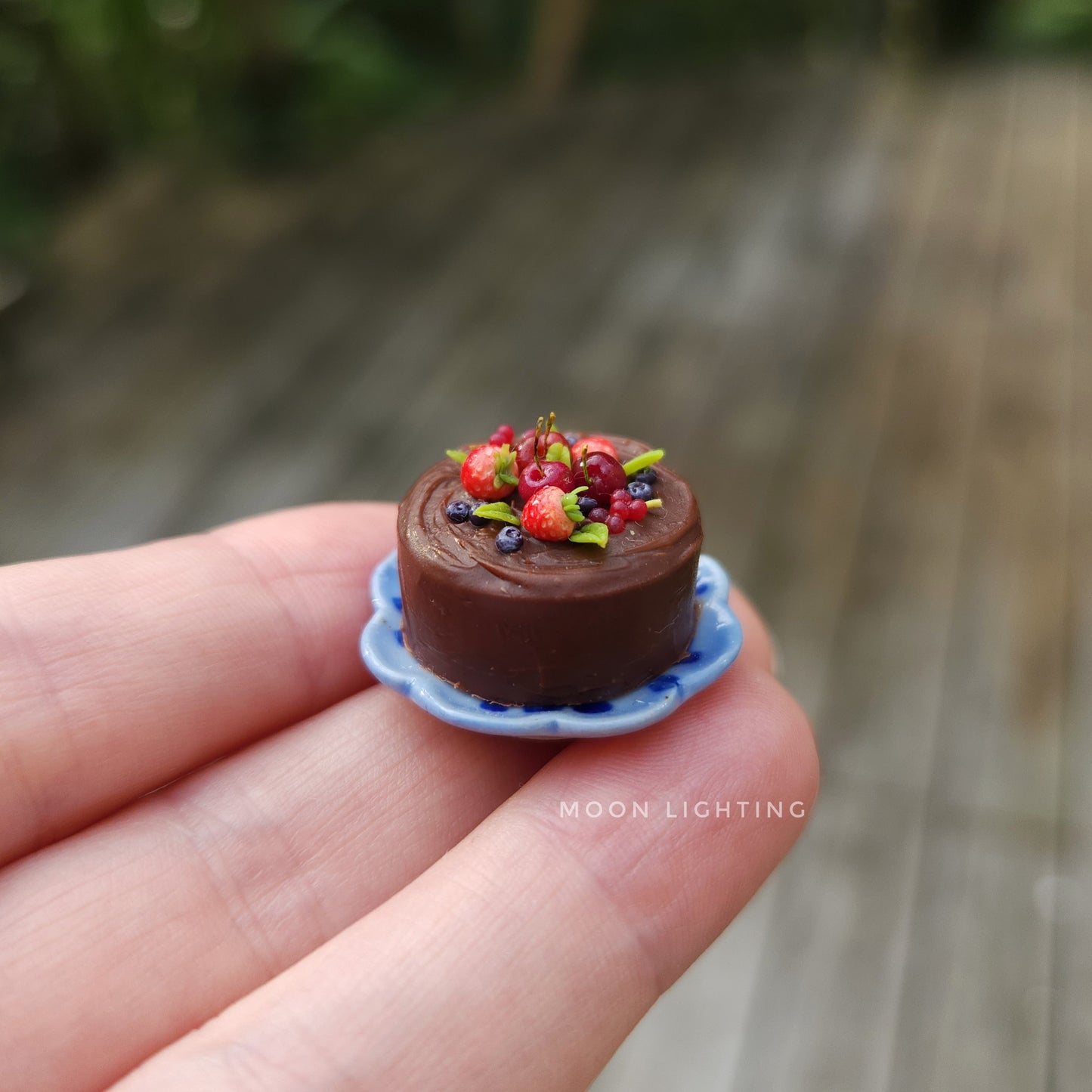 Chocolate cake with berries on blue plate
