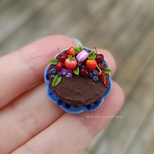 Chocolate and berry cake on blue plate