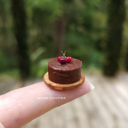 Tiny chocolate cake with cherries