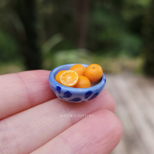 Blue bowl of oranges