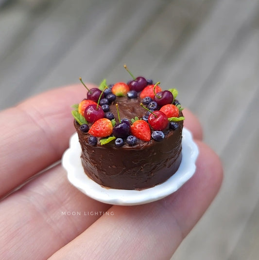 Chocolate cake with berries on scalloped white plate