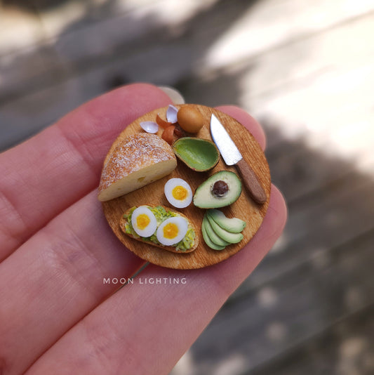 Avocado toast with eggs on round board with knife