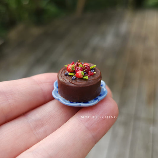 Chocolate cake with berries on blue plate