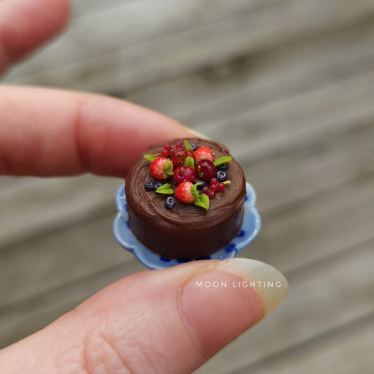Chocolate cake with berries on blue plate