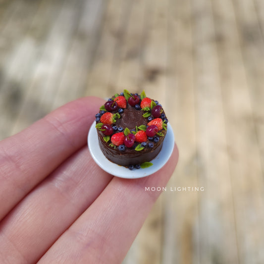 Chocolate cake with berries on white plate